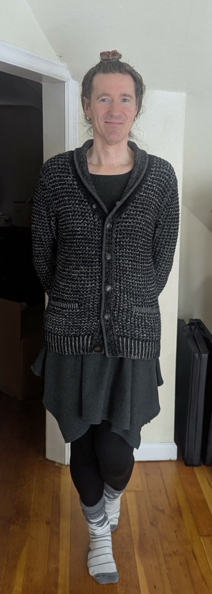 Nathan wearing gray white striped socks, black leggings, gray dress, rag + bone cardigan, with hair up in a bun.